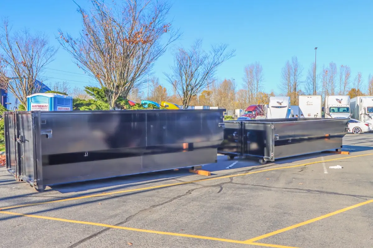 Professional dumpster rental service with roll-off container on residential driveway in Kenmore